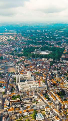 Vertical video. Ghent, Belgium. Panorama of the city from the air. Cloudy weather, summer day, Aerial View. Rich colors