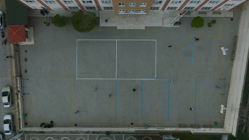 Aerial Video Overhead View of a School Playground with Swings, Slides, and a Sports Area A dynamic area for physical activity and learning.