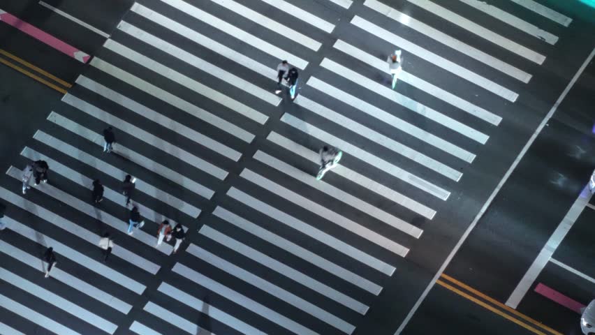 People crossing the road at a zebra crossing on a green light in Yeouido, South Korea.