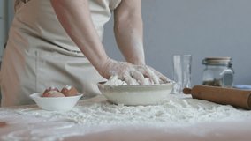The cook in the bakery kneads the dough with his hands and begins to prepare the bread and pasta using traditional methods. Slow motion. - Powered by Shutterstock - Get 15% off with code: PIKWIZARD15