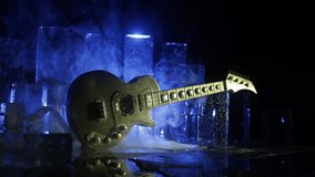 Music Concept: Guitar Miniature on a Dark Background with Vivid Light, Smoke, and Fire Effects. Golden electro guitar under a Dramatic Spotlight. İce Glass blocks decor - Powered by Shutterstock - Get 15% off with code: PIKWIZARD15