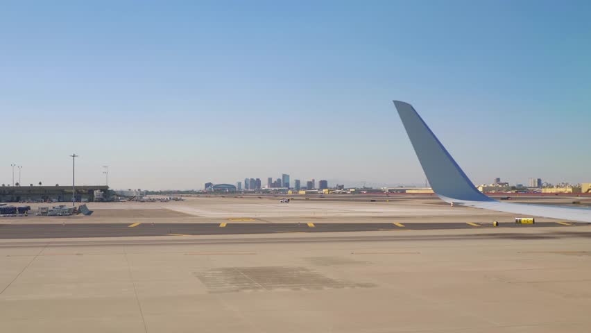 Airplane wing view during landing at Phoenix, Arizona, USA in 4k slow motion 60fps