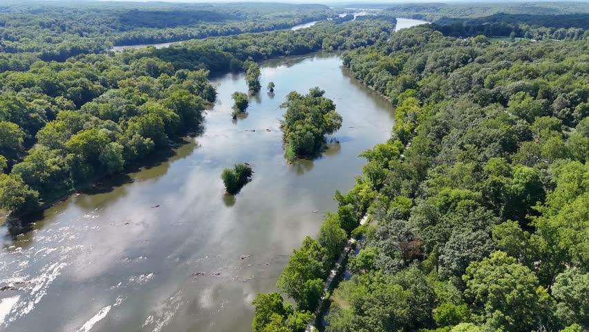 A cinematic drone shot pans up, showcasing the Potomac River. The water