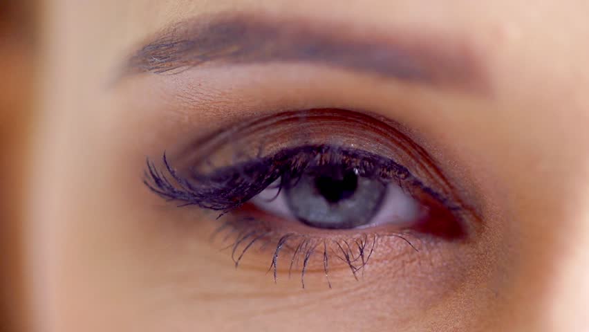 Close Up Shoot on Eye of Young Woman With Natural Makeup in Slow Motion
