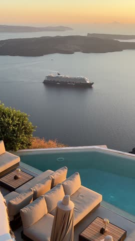 Beautiful sunset in Santorini island, Greece. Luxury swimming pool with blue water. Blue sea and the blue sky at sunset. Summer travel and vacation. Vertical video