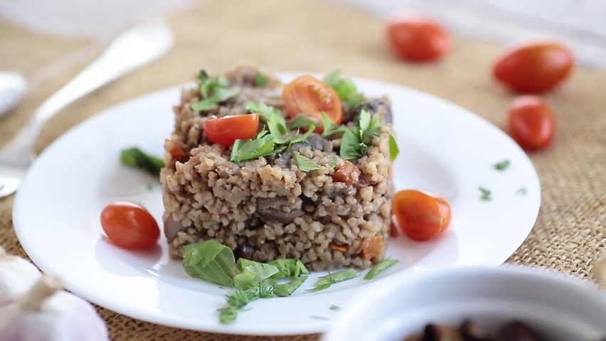 cooked bulgur with mushrooms and vegetables.