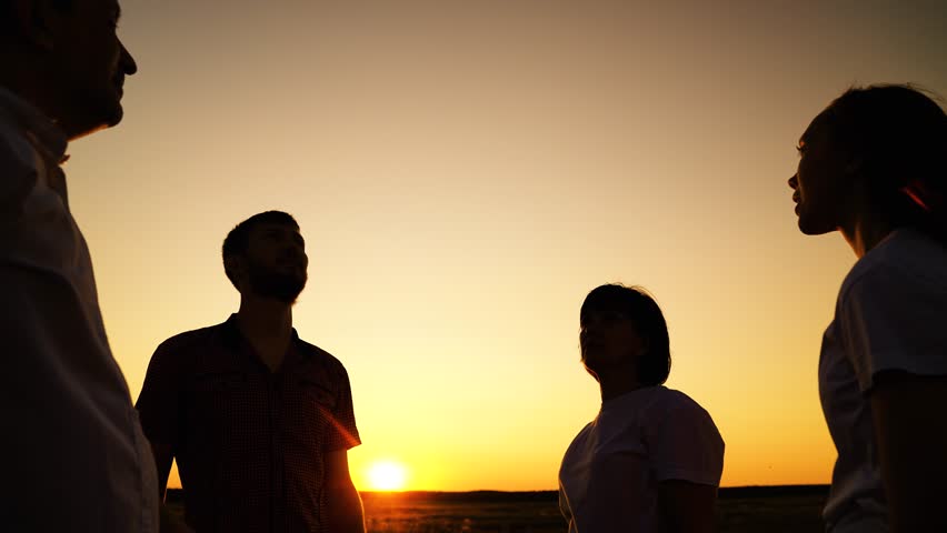 Business people. People united by common idea. Group people raise hands sky, join palms together close-up. Team spirit, holds hands. People connect palms hands close-up against sky. Concept teamwork