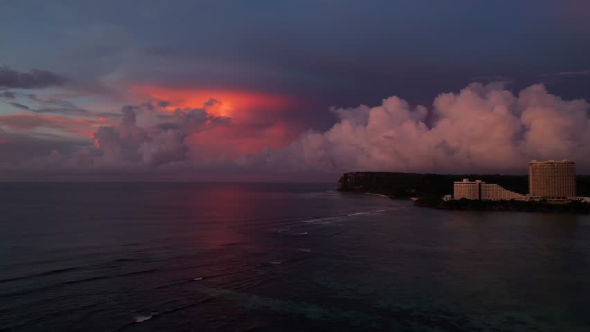 Drone Flys Over Ocean Toward Big Clouds At Sunset, Guam