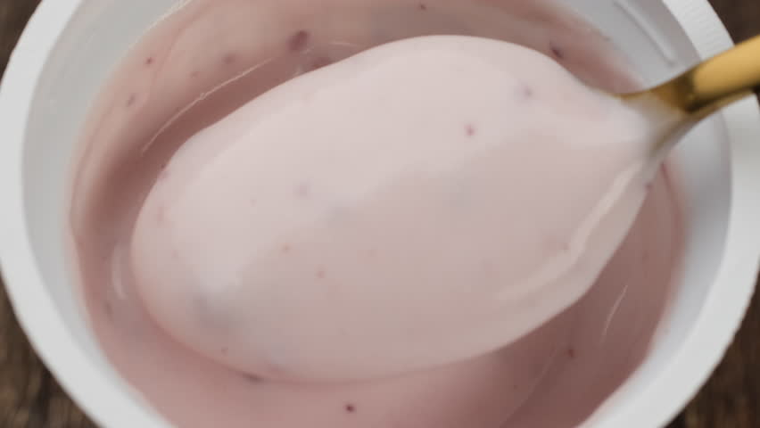 Fruit Yogurt Scooped with Golden Spoon from Bowl, Macro 