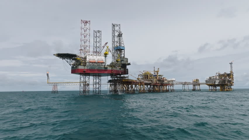 Dolly shot of offshore processing platform near Vietnam coast, oil and gas industry