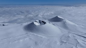Etna summit area in winter with a landscape with snow covering craters and volcanic rocks. The smoke from the eruptions creates a unique atmosphere. Above the clouds. Etna cable car.
 - Powered by Shutterstock - Get 15% off with code: PIKWIZARD15