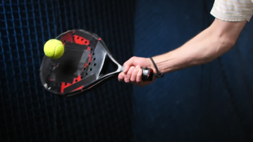 Isolated padel racket and ball hit impact in action against black background, 4k slow motion video footage