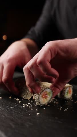 chef prepares delicious Japanese rolls