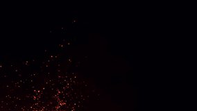 Hot burning fire sparks rising in the night sky. Ember fire particles flowing with the wind. Fire ashes closeup. Bonfire sparkles, firestorm, campfire, and natural disaster. Fiery glowing sparks. 4k. - Powered by Shutterstock - Get 15% off with code: PIKWIZARD15