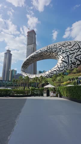 Exploring a modern art structure in an urban landscape with skyscrapers