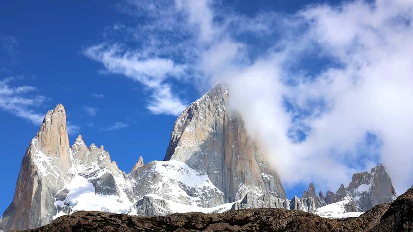 Fitz Roy mountain summit in Patagonia stunning landscape video with clouds moving above the top of granite peak standing above the lake. Beautiful scenic landscape of Patagonia in Argentina El Chalten