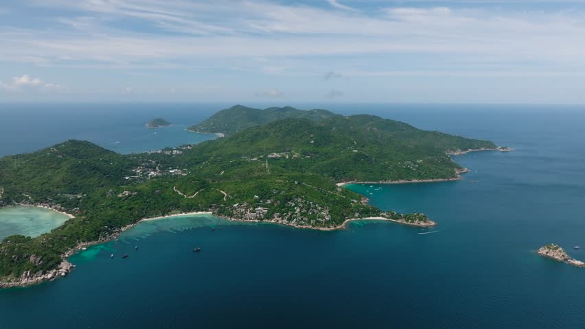 Tropical landscape of island with sandy beaches and rocky formations at coast. Shark Bay. Koh Tao, Thailand.