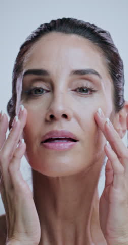 Mature woman, skincare and results in studio with face, check and process for beauty by background. Person, model and smooth in portrait for cosmetics, glow and anti aging transformation in Greece