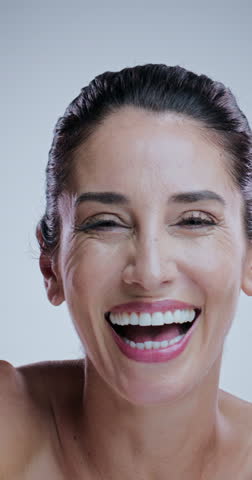 Laugh, skincare and mature woman in studio for anti aging cosmetics, results and face transformation. Dermatology, salon and portrait of person for facial, wellness and beauty on white background