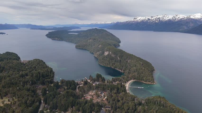 Amazing panoramic aerial movement over the Parque Nacional Los Arrayanes with serene Nahuel Huapi lake, Argentina.
