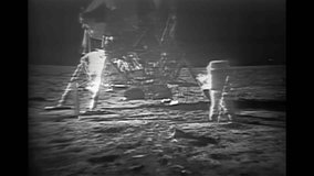 Historic Apollo 11 moon landing. NASA astronauts on the moon with lunar module. Apollo11 moonwalk video. Space exploration on the moon. Apollo 11 moon astronauts in space suits on the lunar surface. - Powered by Shutterstock - Get 15% off with code: PIKWIZARD15