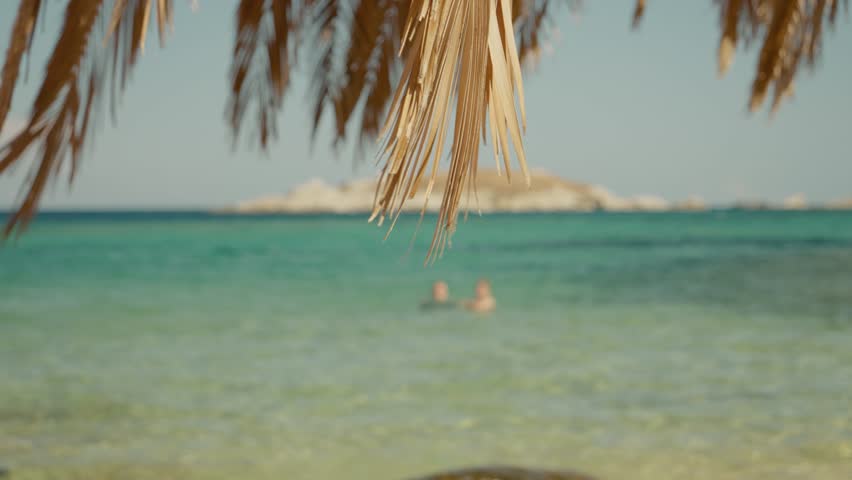 Sand blurred tropical beach blue sky bokeh background summer. Wave water splash pattern shore sunshine. Text Space area.