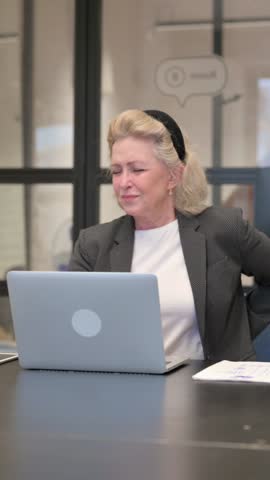 Senior Old Business Woman having Back Fatigue and Pain in Office
