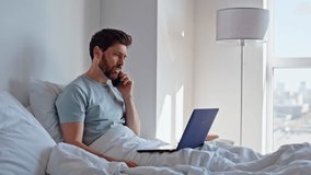 Worried ceo complaining cellphone sitting bed closeup. Nervous businessman having bad smartphone conversation discussing business problems at bedroom. Sick man talk mobile phone with doctor at home  - Powered by Shutterstock - Get 15% off with code: PIKWIZARD15