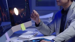 A disappointed business investor team focused loss profit individual analyzing stock market data on multiple screens in a dimly lit office environment. - Powered by Shutterstock - Get 15% off with code: PIKWIZARD15