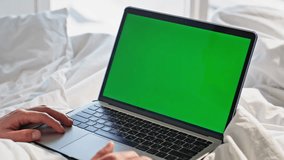 Hands working mockup laptop at home morning closeup. Unknown man freelancer using green screen computer touchpad browsing website in white bed. Male student studying online in cozy bright bedroom - Powered by Shutterstock - Get 15% off with code: PIKWIZARD15