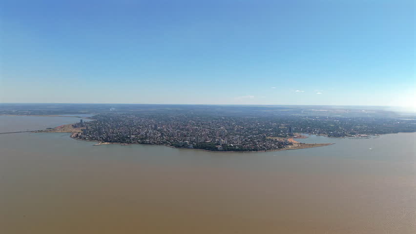 Discover Posadas, the capital of Misiones Province in northeastern Argentina, through a stunning panoramic aerial view bordered by the Paraná River.