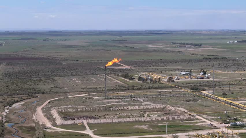 Distant aerial view of a gas tower in open fields and rural setting, Bahía Blanca, Province of Buenos Aires, Argentina.