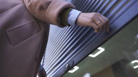 Female Business Owner of Local Store opening garage storefront - Powered by Shutterstock - Get 15% off with code: PIKWIZARD15