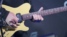 Close-up of a musician playing a gold electric guitar, showcasing their hands and the instrument during a live music performance. Suitable for themes of music, performance, and instrumental artistry. - Powered by Shutterstock - Get 15% off with code: PIKWIZARD15