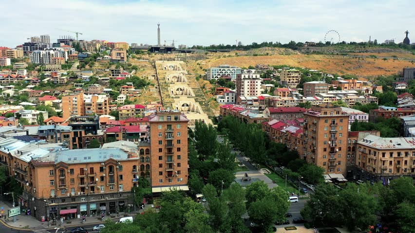 An aerial footage buildings near Cascade Complex in Yerevan, Armenia. The upper levels reveal Soviet-era and modern buildings, blending Yerevan’s architectural heritage.