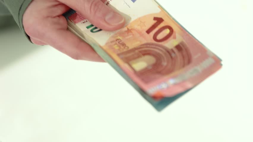 Close-up of two people exchanging a stack of euro banknotes, symbolizing financial transactions, business payments, loans, or cash deals. 4k high quality slow motion stock video