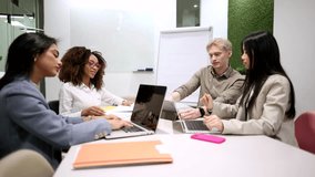 Multiracial business team working together on a project in a modern coworking space, engaging in productive discussion and utilizing laptops and tablets - Powered by Shutterstock - Get 15% off with code: PIKWIZARD15