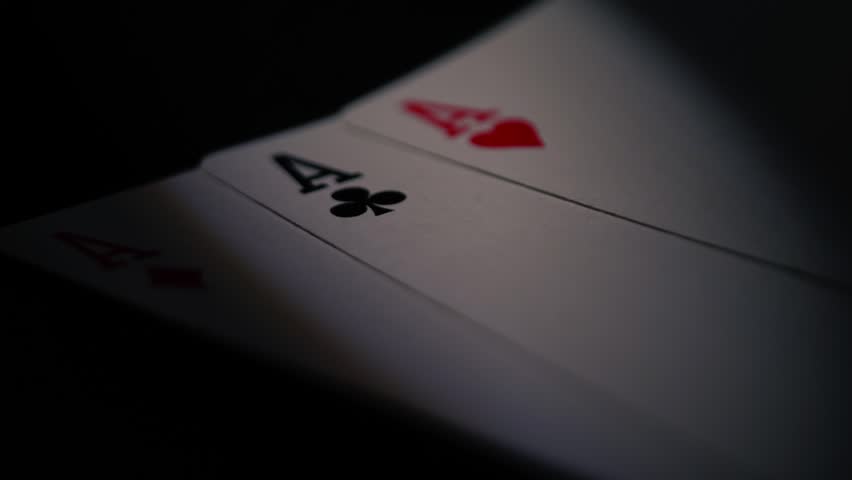 Poker player holding aces playing cards close up zoom shot selective focus