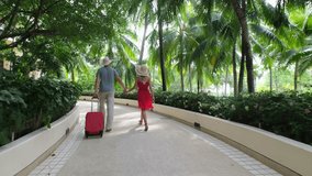 Happy family holiday young traveler woman man walking with suitcase at luxury tropical island Phuket summer garden, Tourist couple in spa resort hotel. Travel tourism sea ocean beach vacation relax - Powered by Shutterstock - Get 15% off with code: PIKWIZARD15