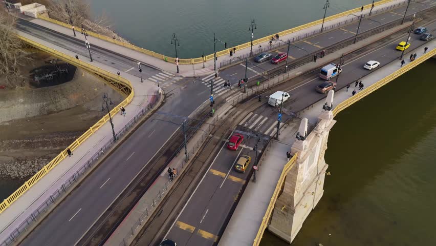 Pull out drone shot over Margaret Bridge and Danube River in the day in Budapest, Hungary