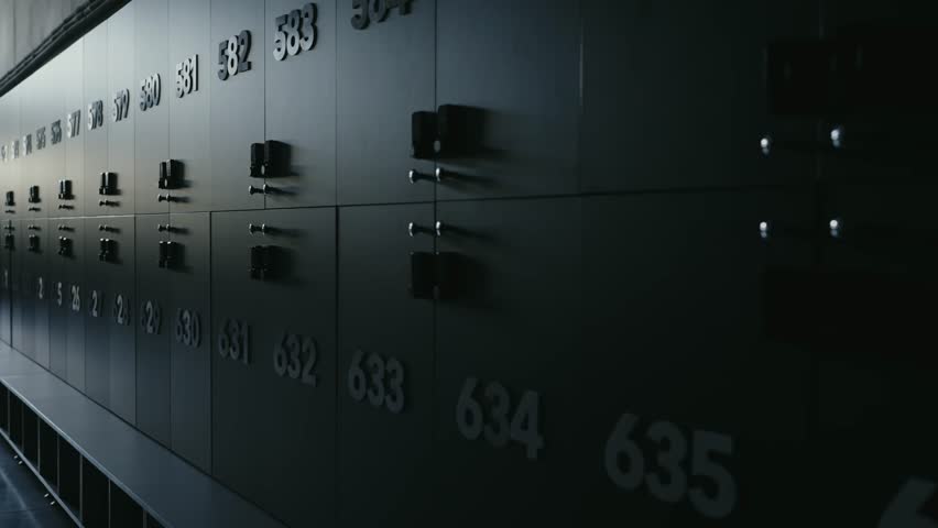 Close-up shot of a row of numbered gym lockers with locks in a modern fitness facility. The image depicts order, security, and the functional design of the gym's interior. Lockers with Numbers