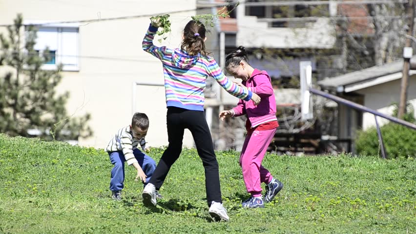 Family throwing grass and leaves in air