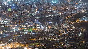 City panorama with Rike Park at night from above. Modern urban park in the old town of Tbilisi aerial timelapse. Illuminated Bridge of Peace and air balloon with historic and modern buildings. Georgia - Powered by Shutterstock - Get 15% off with code: PIKWIZARD15