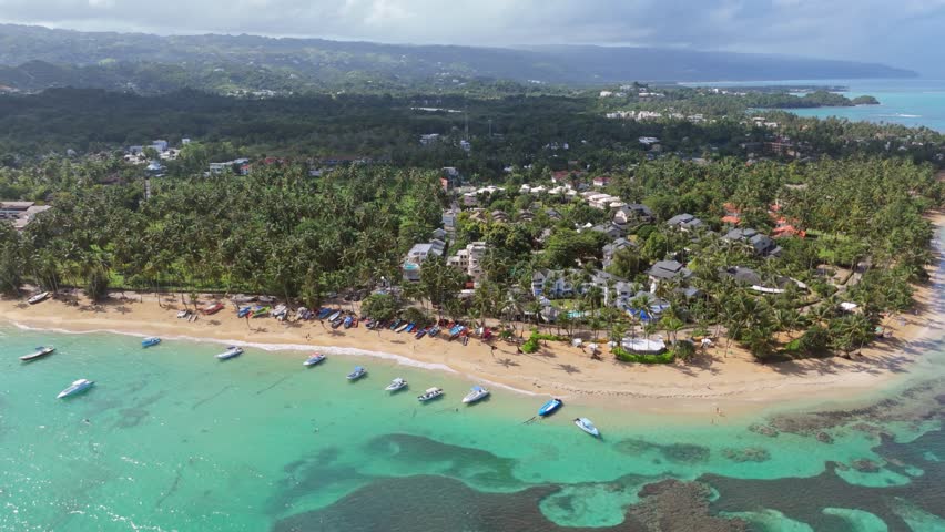 Boats Floating Along The White Sandy Beach, Resort And Hotels In Las Terrenas, Dominican Republic. - aerial shot