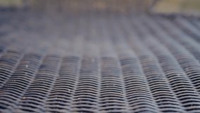 Intricate close-up view of a wicker chair highlighting its texture and pattern. Ideal for themes of comfort, outdoor furniture, and craftsmanship. Wicker Chair with Focus on Texture and Pattern - Powered by Shutterstock - Get 15% off with code: PIKWIZARD15