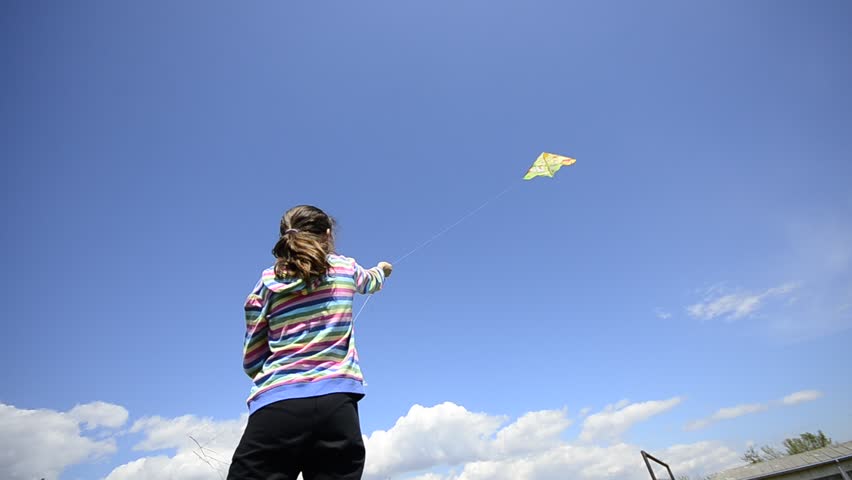Young kid flying a kite, wide angle