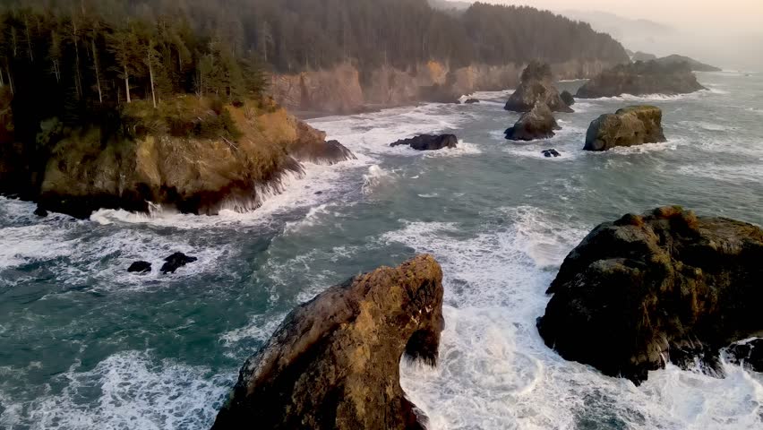 Aerial of the rugged coastline of Oregon, USA at Sunset.