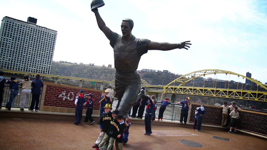 PITTSBURGH, PA - CIRCA APRIL 2013: Sports fans pose at the statue of Bill