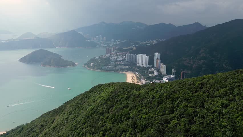 Repulse bay, Hong Kong: Cinematic aerial drone footage of the famous Repulse bay with apartment tower and beach in Hong Kong island on a cloudy day