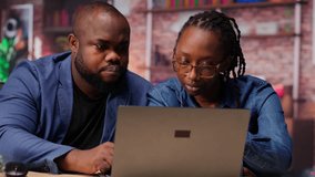 Freelancers filling in spreadsheets on laptop by entering data from report papers, analyzing figures at the end of the month. African american man and woman working from home. Camera B. - Powered by Shutterstock - Get 15% off with code: PIKWIZARD15